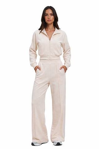 Woman wearing a beige jumpsuit on a white background